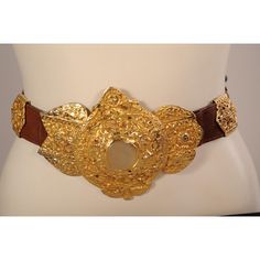 This supple brown leather belt is embellished with a large gold toned buckle and seven decorative slides in two different styles. The belt is stamped  Made in Italy by Roberta Di Camerino Expressly for Saks Fifth Ave. It is in excellent condition and appears unworn. Measurements; Belt  Length 32" Width 1 3/8" Buckle Height 5"  Please see the measurements noted above in the description for best approximate dimensions Elegant Brass Belt Buckles, Luxury Brown Belt With Brass Buckle, Designer Brown Belt Buckles With Gold Buckle, Designer Brown Belt With Gold Buckle, Luxury Formal Belt With Antique Buckle, Designer Brown Belt Buckles, Designer Formal Belt With Brass Buckle, Vintage Gold Belt Buckle With Antique Detail, Gold Antique Buckle Vintage Belt Buckle