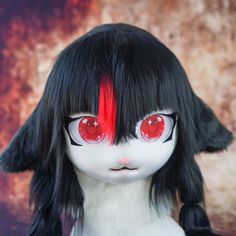 a doll with black hair and red eyes