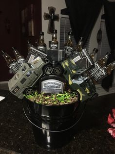 a black bucket filled with lots of liquor bottles