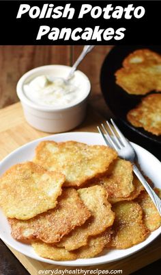 potato pancakes on a plate with butter and sour cream in the background