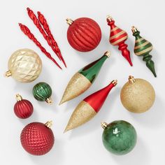 an assortment of christmas ornaments arranged on a white surface