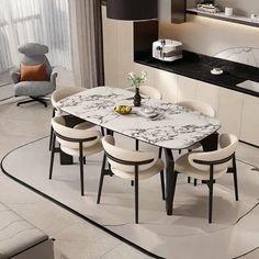 a dining table with four chairs and a vase on it in the middle of a room