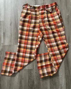 "Vintage Pants  - Burnt Orange  - Rare colour way  - Plaid pattern  - Flared leg  - 60's vintage  - Made in Canada  - MacQueen branded  Polyester/wool/unknown material  65%/25%/10% Size: 34\" waist 30\" inseam  Good vintage condition No rips or holes  No stains" Retro Straight Leg Pants For Fall, Retro Straight Leg Fall Bottoms, Retro Straight Leg Bottoms For Fall, Retro Cotton Pants For Fall, Retro High-waisted Pants For Fall, Fall Retro High-waisted Pants, Retro Red Bottoms For Fall, Retro Multicolor Fall Pants, Retro Plaid Wide-leg Pants