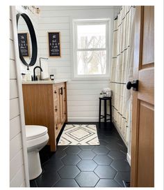 a bathroom with black and white tile flooring