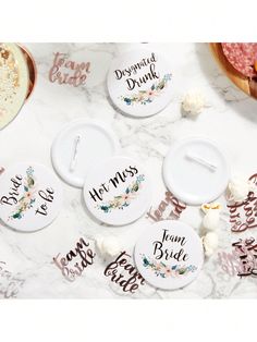 four personalized coasters sitting on top of a marble table with confetti