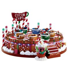 a chocolate cup display with candy canes and candies on it's sides