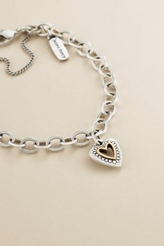 With a delicately scalloped silver border that frames a bronze center heart, this petite charm is an endearing way to express your love. Engravable on the back, it pairs wonderfully with other heart charms, pendants, earrings and rings. Sterling Silver Heart Charm Jewelry, Silver Metal Jewelry With Heart Charm, Silver Charm Bracelet With Heart Pendant, Silver Heart-shaped Jewelry With Heart Charm, James Avery Valentines Charms, James Avery Charm Bracelet, James Avery Bracelet, James Avery Charms, James Avery