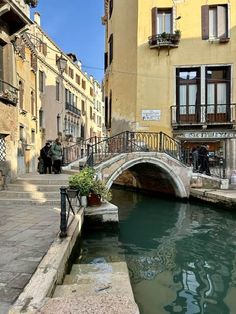 a bridge over a small canal in an old city