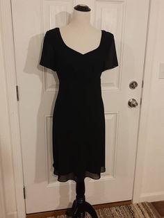 "Vintage Womens Special Occasion Black Lined Spring/Summer Dress Size M-L Excellent Vintage Condition.  Very Clean, No Tears Or Snags.  Shows Little Wear Made By Blushe Spiegel, Marked Size 12 Polyester/Acetate Black Sheer Outer Layer Black Soft Taffeta Lining Sweetheart Neckline Empire Waist Short Semi Sheer Sleeves 16\" Black Nylon Back Hidden Zipper Fabric Hangs Beatifully Knee Length Or Above/Below Depending On Height Bust 40\" Waist 34\" Hips 43\" Sleeves 8\" Length 36\" Weight 14 Oz" Classic Vintage Evening Dress For Summer, Summer Short Sleeve Mini Evening Dress, Summer Mini Dress With Short Sleeves For Evening, Vintage V-neck Evening Dress For Summer, Classic Summer Dress For Night Out, Elegant Black Vintage Dress For Summer, Elegant Black Vintage Summer Dress, Classic Fitted V-neck Vintage Dress, Black Knee-length Vintage Dress For Summer