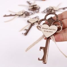 a hand holding a key to a bunch of keys