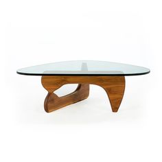 a glass and wood coffee table with curved legs