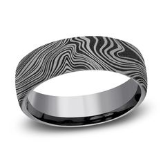 a wedding band that is black and white with an animal print pattern on the inside