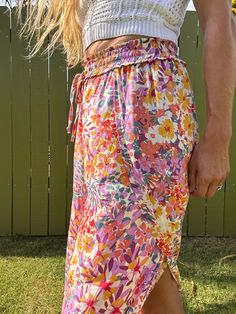 Ditch those boring trousers and upgrade to our Tulip Gardens beach pants! Featuring a flared leg and unique split tulip hem, these printed pants will have you turning heads. Made with 100% rayon for a comfortable and stylish fit. Get ready to stand out in these fun and playful pants! Bohemian Floral Print Beach Bottoms, Bohemian Printed Bottoms For Beach Season, Bohemian Floral Beach Bottoms, Summer Floral Print Wide-leg Bottoms, Multicolor Floral Print Bottoms For Day Out, Multicolor Beachy Bottoms For Festival, Summer Floral Print Wide-leg Pants, Spring Summer Harem Pants With Relaxed Fit, Bohemian Floral Print Bottoms For Beach Season