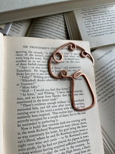 an open book with some metal scissors on top of it