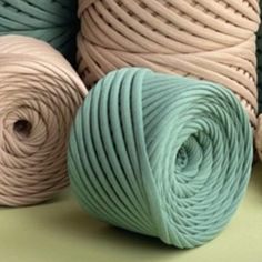 three skeins of yarn sitting next to each other on top of a table