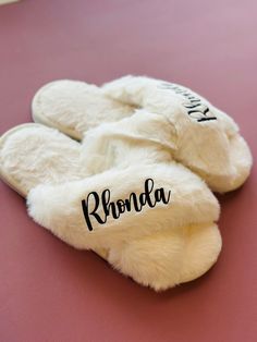 "**Slippers**  Made of soft faux rabbit fur, premium cotton, and memory foam - making them warm, comfortable, and skin-friendly. They also have a non-slip sole.  1. Select Primary Color and Size (listed in women's US sizes) 2. Select Font Color (colors in picture do not reflect actual color, message me if needing to see a specific color or request a different color that is not listed) 4. Add Personalization Bulk order discount is available for 5 or more orders Message me for details ✏️ ALSO OPTIONAL :: include a personal message to the recipient on a card - write your message in the \"add personalization\" section Consider adding a robe to your order to make a set :: https://www.etsy.com/listing/1403097079/personalized-silk-robe-set-furry-house?click_key=1e1d5cc0cebdc3e5c0fda2be6ce0e87dbe7 Cozy White Slippers With Plush Lining, Comfortable Fluffy White Slippers, White Fluffy Indoor Slippers, Fluffy White Indoor Slippers, Personalized Slippers, Wedding Slippers, Handmade Slippers, Ear Tag, Gifts Baby