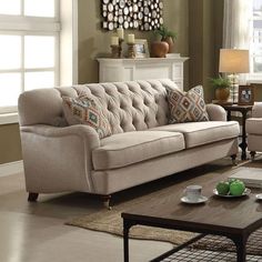 a living room with two couches and a coffee table in front of a window