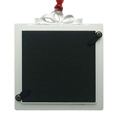 a black and white photo frame with a bow on it's top hanging from a red string