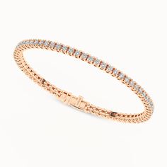 The Essential Tennis Bracelet exemplifies the magnificence of your beauty. Its string of glistening diamonds radiates luxury from every angle, and its minimalistic design makes you shine in all your glory. The diamond bracelet has a secured top GB lock that ensures the bracelet is secured and feels comfortable. Rose Gold Diamond Tennis Bracelet With Jubilee Style, Everyday Luxury Rose Gold Cubic Zirconia Tennis Bracelet, Classic Rose Gold Bracelet With Brilliant Cut, Timeless Rose Gold Diamond Bracelet With Prong Setting, Timeless Rose Gold Tennis Bracelet, Rose Gold Diamond Tennis Bracelet With Prong Setting, Elegant Rose Gold Tennis Bracelet With Prong Setting, Rose Gold Diamond Tennis Bracelet Brilliant Cut, Rose Gold Diamond Bracelet With Prong Setting