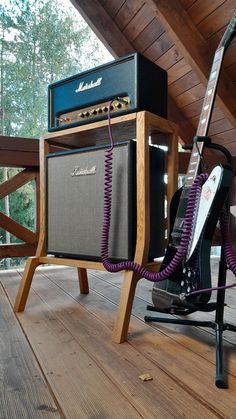 an amp and guitar stand on a porch