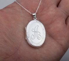 Carrying the pictures of your loved ones close to your heart all the time, this large personalized locket necklace features:1. a large (33 x 23 mm without bale), highly polished oval solid sterling silver locket (8.5 grams) that     can be engraved on the front and back (use pulldown menu to select); the front is perfect for a monogram engraving. The back has a larger area that allows for longer text engraving. Also possible are clipart style pictures, handwriting, fingerprint*, badge, map, logo Classic Oval Personalized Locket Necklace, Classic Personalized Oval Locket Necklace, Personalized White Gold Locket Necklace For Memorial, Elegant Oval Locket Necklace For Personalized Gift, Personalized Oval Pendant Locket Necklace For Keepsake, Personalized Oval Pendant Locket Necklace, Engraved Oval Pendant Locket Necklace, Personalized Oval Pendant Locket Necklace As A Gift, Personalized Sterling Silver Locket Necklace For Memorial