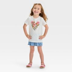 Help your little one take on their day in cute style with this Short-Sleeve Floral Graphic T-Shirt from Cat & Jack™. Crafted from lightweight jersey fabric and featuring a tagless design, this short-sleeve T-shirt brings cool comfort to their day, while the below-waist length gives them the option of wearing it tucked in or untucked. Designed in a cream hue, this crewneck tee features pink and yellow flowers arranged in a heart shape on the front for sweet style. Cat & Jack™: Designed for all ch Cotton Short Sleeve T-shirt For Playdate, Cute Cotton T-shirt For Playdate, Cute Short Sleeve Tops For Playdate, Cotton Graphic Print Top For Playdate, Cute Casual Cotton Tops, Casual Tops With Graphic Print For Playdate, Casual T-shirt For Playdate, Spring Playtime Short Sleeve T-shirt, Playful Summer T-shirt For Playdate