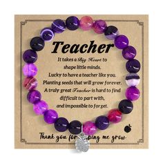 a purple and black beaded bracelet with an inspirational quote on it that says teacher