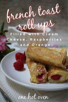 french toast roll ups filled with cream cheese, raspberries and orange juice on a white plate