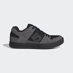 a grey and black shoe with the letter o on it