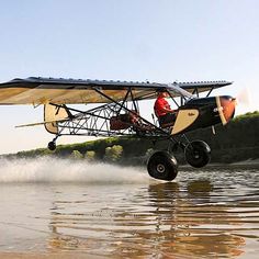 an airplane is flying low over the water