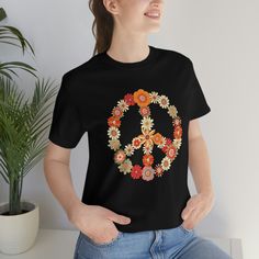 Peace sign tshirt. A floral peace sign t-shirt is a fun and colorful way to express your love for peace and nature. The shirt features a large peace sign in the middle of the chest, covered by a variety of brightly colored flowers in different shapes and sizes. It is made of soft, comfortable material, making it perfect for casual wear. It runs true to size and has a tear away label. This shirt is a great way to show off your unique style and spread positive vibes wherever you go! Floral Peace Sign, Peace Sign Shirt, 70s Theme, Peace Sign Shirts, Alien Shirt, 1970's Fashion, Winter Shirts, Retro Mode, Retro Vintage Style