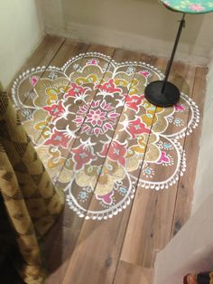 the floor is made out of wood and has an intricate design on it, as well as a black umbrella