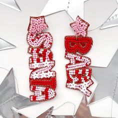 Get into the festive spirit with our Santa Baby pink and red Christmas Dangle Earrings!  These playful earrings feature one dangle seed bead earring that says "Santa" and the other "Baby," adding a touch of whimsy to your holiday look. The combination of pink and red hues creates a fun and vibrant accessory that embodies the true essence of Pinkmas joy. Make a statement with these merry earrings, perfect for the holiday season. Whether you're looking for a unique Christmas accessory or a gift that stands out, our Santa Baby earrings are the ideal choice. 🌟 Spread the holiday cheer and add festive flair to your ensemble with these delightful earrings. Get ready to jingle all the way and make your Christmas celebrations extra special! 🎁 🌸 Elevate Your Style with Trendy Earrings! 🌸 Welcom Personalized Pink Jewelry For Christmas, Red Christmas Earrings For Holiday, Red Earrings For Christmas Holiday, Red Beaded Earrings For Party, Red Jewelry For Christmas Birthday, Red Christmas Holiday Earrings, Red Festive Earrings For The Holiday Season, Red Festive Earrings For New Year, Pink Earrings Christmas Gift