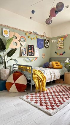 a bedroom with a bed, rug and various decorations on the wall above it's headboard