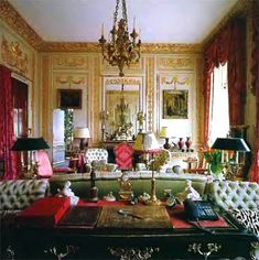 a living room filled with furniture and a chandelier