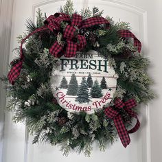 a christmas wreath hanging on the front door