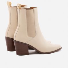 A unique Chelsea boot. Inspired by cowboy boots and western styling, the Bianca Chelsea Boots kick things up a few notches. The semi square toe box, alluring Cuban heel and sculptural shape create a captivating silhouette that will attract the right kind of attention. With a contemporary look and feel, the Biancas love to have fun, and play well with your casual outfits and dressy ensembles. Go ahead, take them for a whirl. This product is made from Gold Rated full-grain calfskin leather sourced Fall Chelsea Boots With Stacked Heel And Square Toe, Chelsea Boots With Square Toe And Reinforced Heel, Chelsea Boots With Reinforced Heel And Square Toe, Western Boots With Block Heel, Western Style Boots With Block Heel, Fitted Western Boots With Block Heel, Western Moto Boots With Stacked Heel And Square Toe, Chic Fitted Chelsea Boots With Square Toe, Chic Moto Boots With Stacked Heel And Square Toe