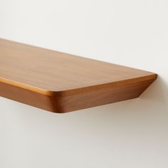 a wooden shelf mounted on the wall