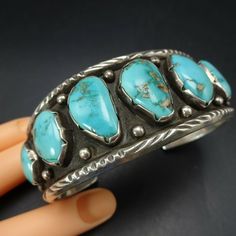 "DESCRIPTION: This exceptional bracelet will be a cherished addition to your collection of fine vintage Southwestern and Native American jewelry. MEASUREMENTS: Interior of the cuff measures 5 5/8\" with an additional 1 1/4\" non-adjustable gap. Total circumference: 6 7/8\" Measures 2 5/8\" straight across the widest part (from wrist bone to wrist bone) Bracelet face measures 1 1/4\" wide (the face of the bracelet, north to south) WEIGHT: 69.8 grams SIGNED: no STERLING: unmarked, verified sterlin Western Style Cuff Jewelry For Gift, Southwestern Blue Cuff Jewelry, Southwestern Cuff Collectible Jewelry, Southwestern Style Collectible Cuff Jewelry, Western Style Blue Cuff Bangle Bracelet, Western Style Blue Bangle Jewelry, Artisan Blue Stamped Bracelets, Artisan Blue Bracelets Collectible, Western Style Blue Cuff Bracelet Gift