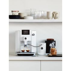 a white coffee machine sitting on top of a counter