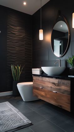 a bathroom with a toilet, sink and mirror on the wall next to a rug