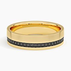 a gold ring with black diamonds on it