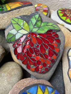 some rocks with different designs on them and one has a heart shaped piece in the middle