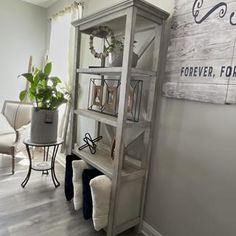 a living room filled with furniture next to a white chair and wall mounted sign that says forever, forever