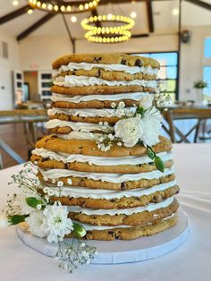 a wedding cake made out of cookies and frosting with flowers on the top tier