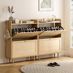 a wooden shelf with shoes on it next to a rug in a white living room