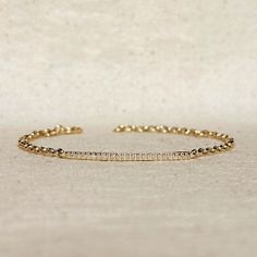 Indulge in the timeless elegance of our 18k Gold Filled 2mm CZ Bar Bracelet. With its modern and minimalist design, this bracelet adds a touch of sophistication to any outfit. The sparkling CZ bar adds a touch of glamour, making it the perfect accessory for any occasion. Elevate your style with this luxurious piece of jewelry. Metal: 18k Gold Filled High-quality Cubic Zirconia AAAAA Width: 1mm micro CZ Stones in a 2mm bar Size: 7" with 3 adjustment options at 6, 6.5 and 7 inches Hypoallergenic W Bar Bracelet, Ear Stack, Jewelry Metal, Bar Bracelets, Cz Stone, Cleaning Clothes, Precious Metals, Minimalist Design, Timeless Elegance