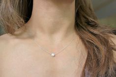 "Dainty, minimalist, layering, necklace or choker for everyday use. Design: FWP Chocker or Necklace Metal: Sterling Silver Stone: Button Freshwater Pearl Chain Style: Swage FWP Diameter: 6 mm Available Lengths: 14\", 15\", 16\", 17\", 18\", 19 Please take note that 14\", 15\" and 19\" are not standard lengths and will be customized as requested. Therefore, it is not returnable. Any stones and pearls are naturally imperfect. ------------------------------------------------------------------------ Simple Pearl Necklace As Gift, Minimalist Everyday Pearl Choker Necklace, Elegant Everyday Charm Necklace With Simple Design, Elegant Sterling Silver Charm Necklace, Minimalist Sterling Silver Necklace With Pearl Charm, Minimalist White Charm Necklaces For Layering, Minimalist Sterling Silver Charm Necklace With Pearl, Minimalist Silver Pearl Necklace, Simple Everyday Pearl Necklace With Clavicle Chain