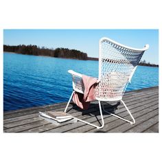 a white chair sitting on top of a wooden dock