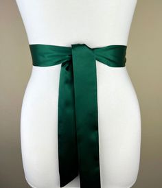 "Narrow Hunter Green Sash  Hunter Satin Sash, Hunter Sash Belt  Bridesmaid Sash, Bridal Sash  Hunter Green Wedding Dress Sash  Satin Swank  This Satin Swank® narrow waist sash is the perfect finishing touch for your wedding, bridesmaid, or special occasion dress, or just the right piece to add instant polish to your dress or top. Depending on your waist size and the length you choose, you can wrap the sash around your waist once or up to three times. You decide whether to tie the sash in a bow or a simple knot with long-hanging tails. Tie in front, in back, or on the side. Made of silky charmeuse satin fabric in hunter green, this sash is hand cut and sewn by Satin Swank®. Sash is the same front and back with ends finished on the angle and seams hidden within the fold lines. SIZING/COLOR/P Satin Sash With Bow For Bridesmaids, Bridesmaid Satin Sash With Satin Bow, Bridesmaid Sash With Satin Bow, Bridesmaid Satin Sash With Bow, Satin Sashes For Bridesmaids, Formal Sashes With Matching Belt, Elegant Fitted Green Sashes, Hunter Green Wedding Dress, Green Wedding Dress